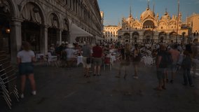 VENICE, ITALY - 2018 : Moving timelapse on St Mark’s square at sunset with Campanile and Basilica in view