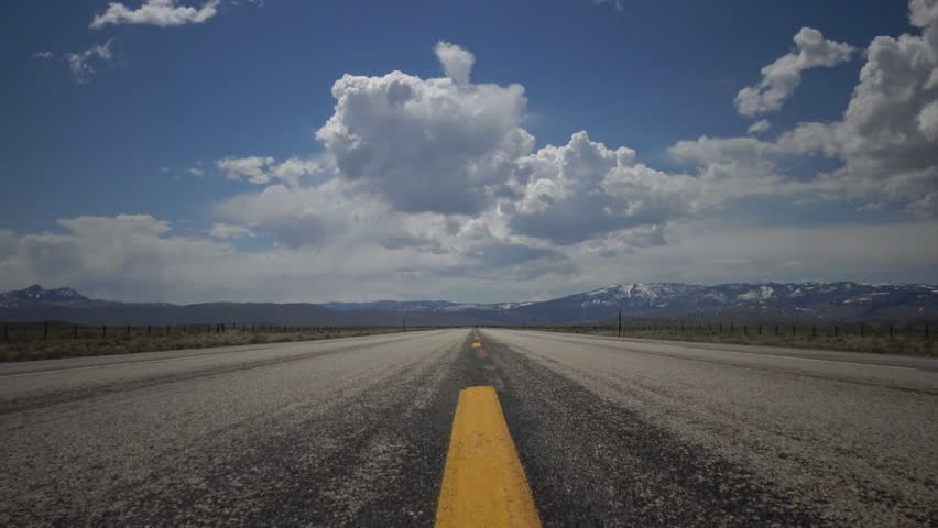 Big white clouds over the highway, landscape with big white clouds, USA North Dakota