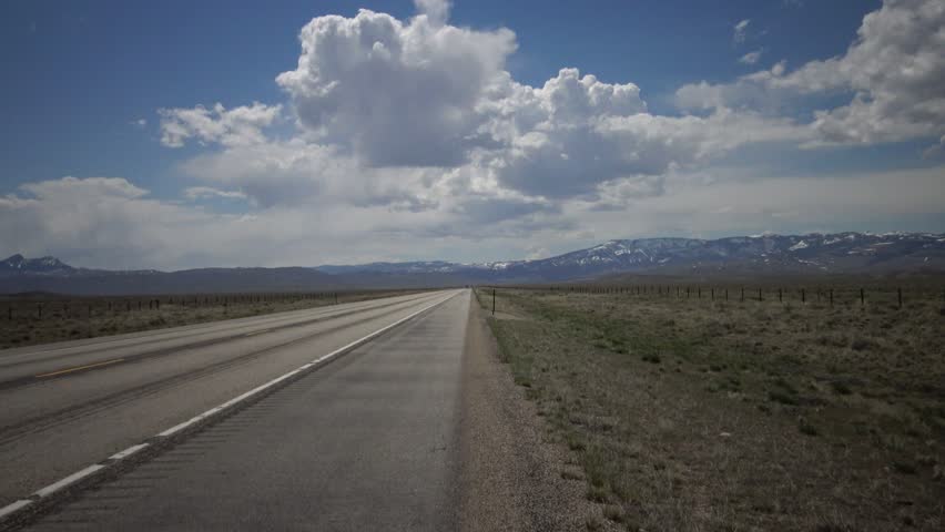 Big white clouds over the highway, landscape with big white clouds, USA North Dakota