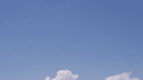 Time lapse clouds, blue clear sky in horizon, summer sunny, white fast moving soft cloudscape panoramic view, motion, building, formating cloudy. UHD.