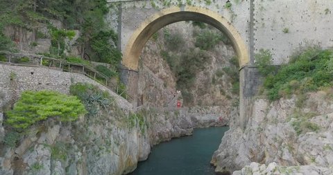 A cinematic setting at amalfi furore where the iconic bridge dominates