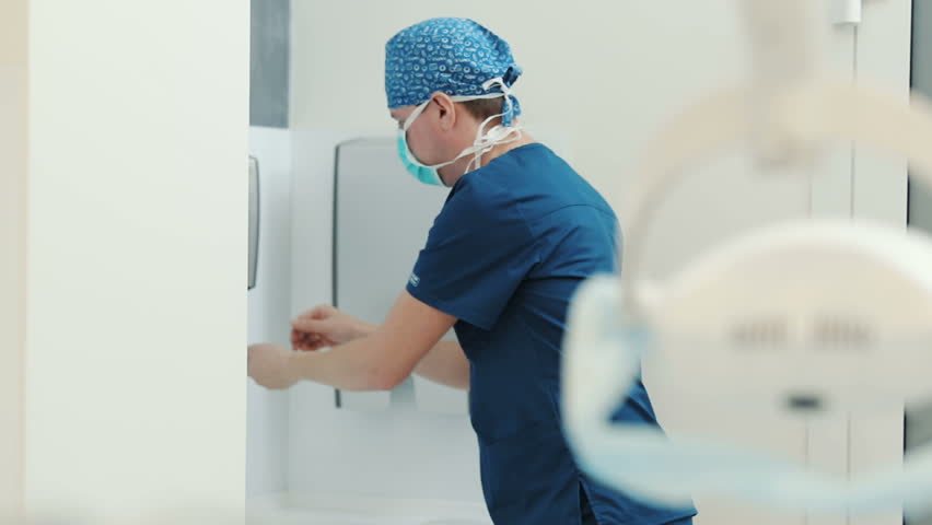 Doctor disinfects and washing his hands dry before entering the operating room. Surgical hand disinfection. Emergency care. Surgery detail in hospital or clinic Royalty-Free Stock Footage #1020530536