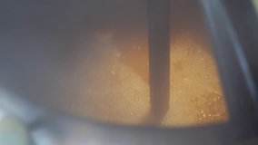 4K Beer production video. Beer cooking process in a brewery. Stirring beer ingredients in the tank close up view. Beer manufacture