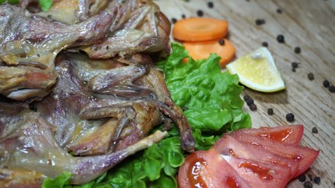 The delicious fried quails served with vegetables. Winterly protein quails. 4K