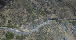 4K high quality aerial summer day footage of spectacular scenic Chapman's Peak Drive, rocky mountains, Atlantic Ocean views between Hout Bay and Noordhoek in Western Cape near Cape Town, South Africa