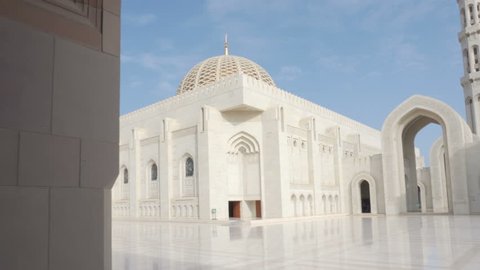 Beautiful view of the Sultan Qaboos Grand Mosque from arched passageway in Muscat, Oman. Amazing Islamic architecture.