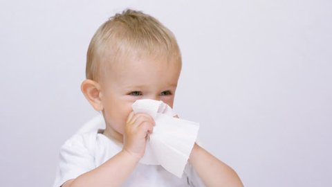 Funny baby wipe the nose with the napkin, amusing independent child take care of his health, flu hygiene, not depending on another for livelihood or subsistence