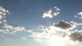 Clear blue sky, time lapse white clouds, beautiful summer sunny day, rolling cloudscape in horizon, real sunny shine, fast moving away, colourful footage.