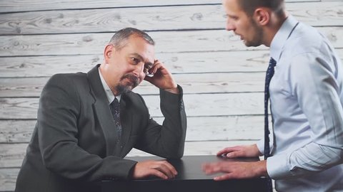 Business anger conflict. Two businessmen shout violently and swear at each other.