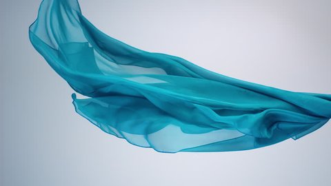 Green transparent fabric flowing by wind, slow motion