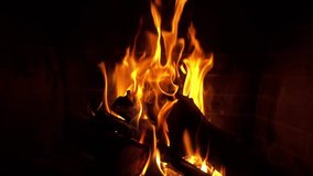 Close up slow motion video of cosy fireplace with beautiful fire reddish colours