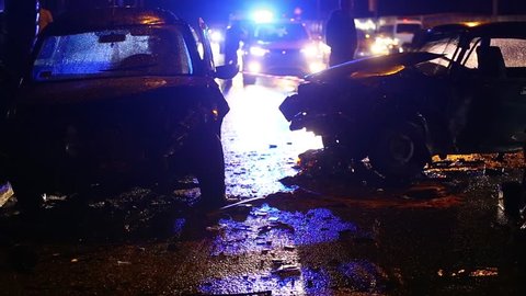 Car accident. Police flashers illuminate the broken cars.