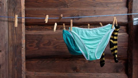 Beautiful underwear dries outside. Women's wet pants on the street dry