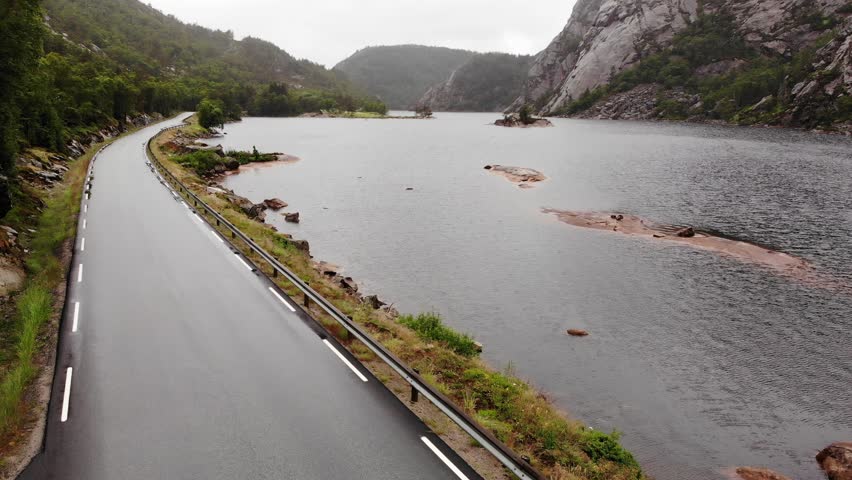 Lake water and road in mountains on overcast day.  Norwegian landscape. Views of tourist county route 44, sothern Norway
