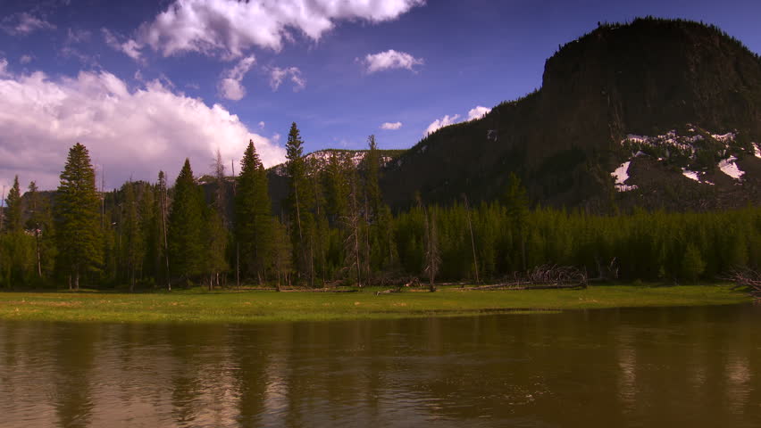 Yellowstone National Park - nice wide establishing shot of Madison river and snow-capped mountains