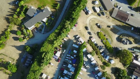 Aerial drone view of campsite or campground, camping pitch place used for overnight stay in outdoor area for camper vans and caravans. 4K footage video.