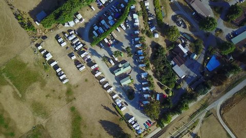 Aerial drone view of campsite or campground, camping pitch place used for overnight stay in outdoor area for camper vans and caravans. 4K footage video.