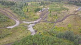 Top view of off-road race track. Clip. Off-road race in mud rural road in wooded area