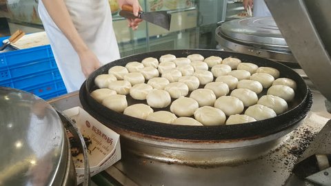 SUZHOU, CHINA - SEPTEMBER 2018: Cooks prepare mooncakes at bakery during popular Mid-Autumn festival in China