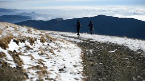 People mountain hiking in winter season on a beautiful day