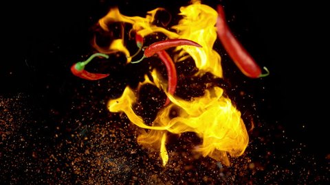 Chili Peppers and Spices in Flames Flying up and Falling down in Slow Motion with Time Remapping. Shot with High Speed Camera, Phantom Flex 4K.