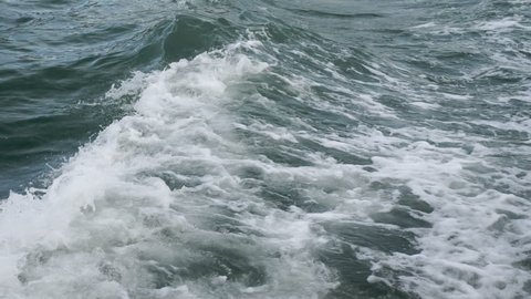 Sea or ocean waves and foam after motor boat or yacht