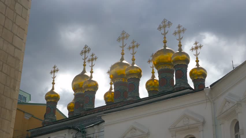 Stunning light on Church of the Deposition of the Robe of Holy Virgin inside Moscow Kremlin with a cloudy sky 