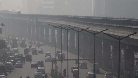 NEW DELHI, INDIA - NOV 24: Metro train and traffic among dangerously high levels of air pollution on November 24, 2018 in New Delhi, India