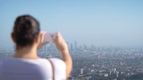 Woman taking picture of downtown in Los Angeles in 4k slow motion 60fps
