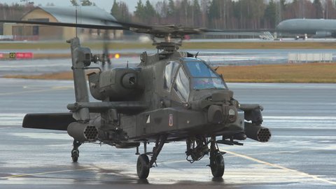 oslo airport norway - ca november 2018: military pair apache ah 64 attack helicopter taxiing on ground medium shoot