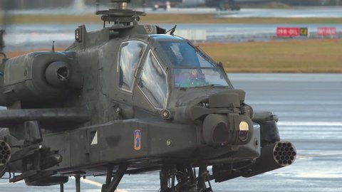 oslo airport norway – ca november 2018: military apache ah 64 attack helicopter taxiing on ground passing close up