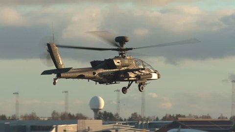 oslo airport norway – ca november 2018: military apache ah 64 attack helicopter in flight panning right