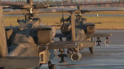 oslo airport norway – ca november 2018: military apache ah 64 attack helicopter running engines zoom out rear view