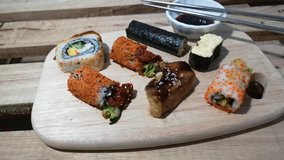 Footage of sushi on wooden board