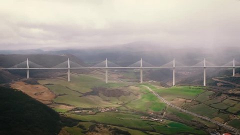 Drone shot of the Millau Viaduct in spring, in the valley of the Tarn, southern France. Le viaduc de Millau par drone au printemps.
