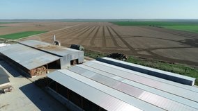 Aerial view of agricultural land and grain silo. Steel Grain Silos Elevators Storage 4K Aerial Video. Agriculture Industry
