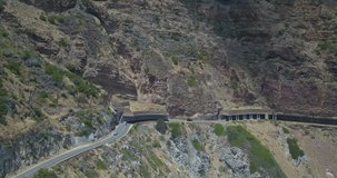 4K high quality aerial summer day footage of spectacular scenic Chapman's Peak Drive, rocky mountains, Atlantic Ocean views between Hout Bay and Noordhoek in Western Cape near Cape Town, South Africa