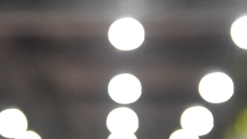 unfocused concert hall. concert hall seats dark night light rays inside exhibition fair blurred mooving camera 