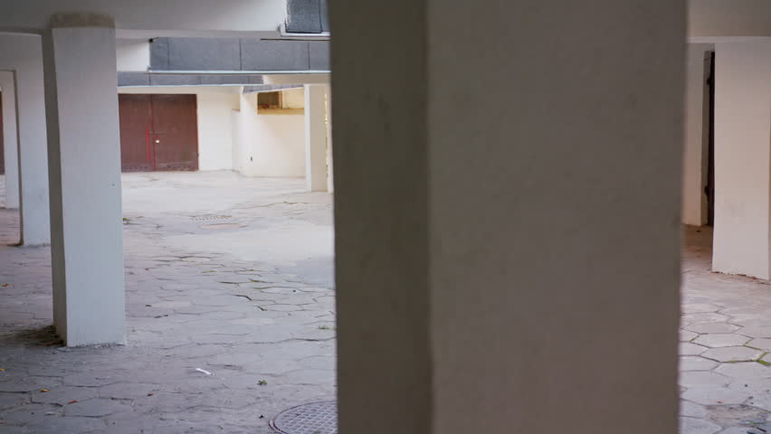 A young woman dancing in the courtyard. Long shot