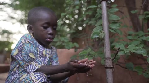 African Boy Cleans Hands with Clean Fresh Water in Bamako, Mali (HD Slow Motion)