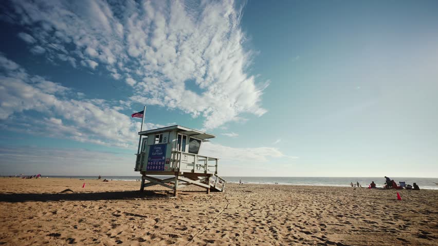 Lifeguard house silhouette at sunset in Santa Monica beach, Los Angeles in sunny day