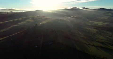 Foggy Peak District scene with wonderful Biblical dawn sunburst drone 4k tracking above fog