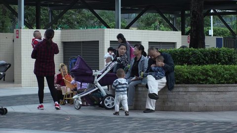 SHENZHEN, CHINA - CIRCA NOVEMBER 2018 : CHILDREN and PARENTS relaxing at residential area in Futian district.