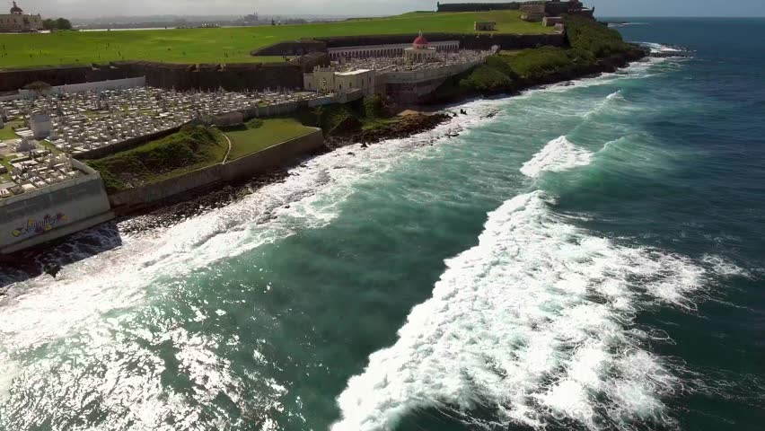 Aerial shot coming from ocean towards famous cemetery in Old San Juan, PR