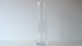 Vertical, front view of empty clear jar which is being filled with thousands of colorful jelly beans poured into it from above in slow motion - Powered by Shutterstock - Get 15% off with code: PIKWIZARD15