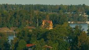 Nordic coastline aerial drone footage. beautiful houses coast forest and water. Filmed in Full HD with a telephoto zoom lens.