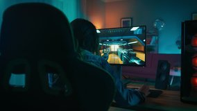 Back Shot of a Gamer Girl Playing First-Person Shooter Online Video Game on Her Powerful Personal Computer. Room and PC have Colorful Warm Neon Led Lights. Cozy Evening at Home.