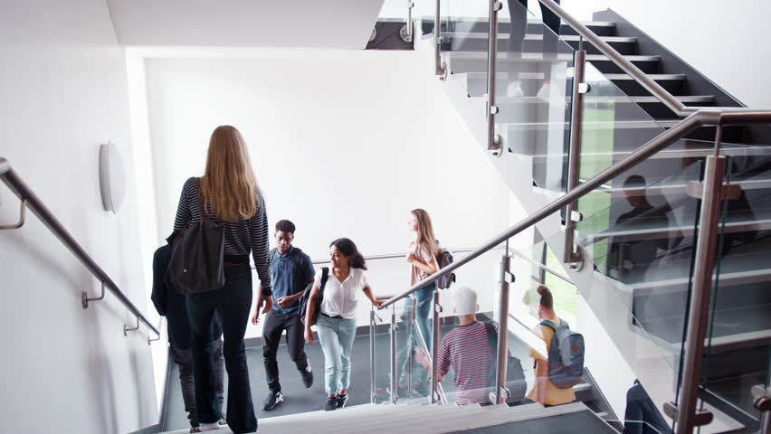 High School Students And Staff Walking On Stairs Between Lessons In Busy College Building Royalty-Free Stock Footage #1020761734