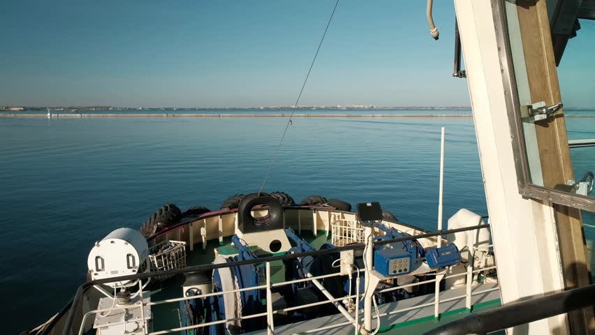 View of the front bow part of the towing vessel sailing into the sea on a bright sunny day. Ship towing