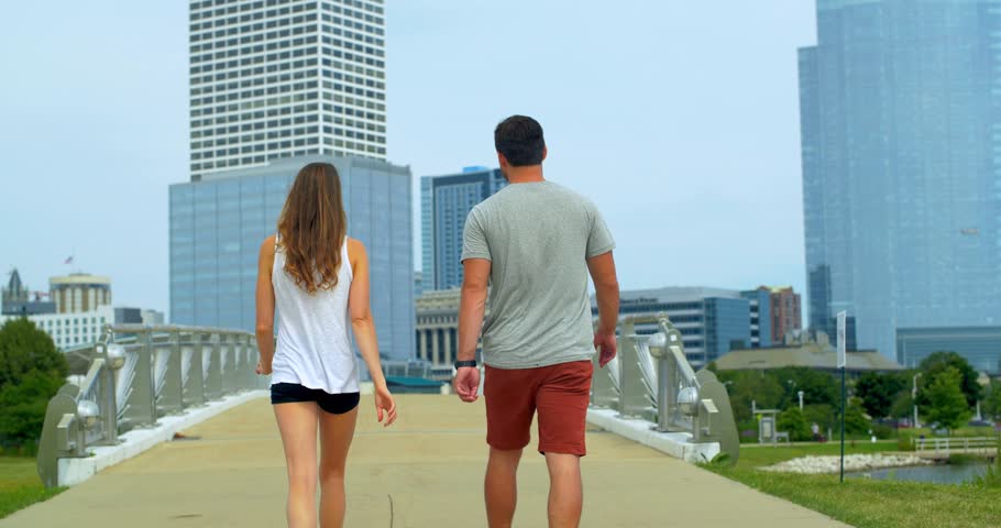 Couple Walks Bridge In Milwaukee